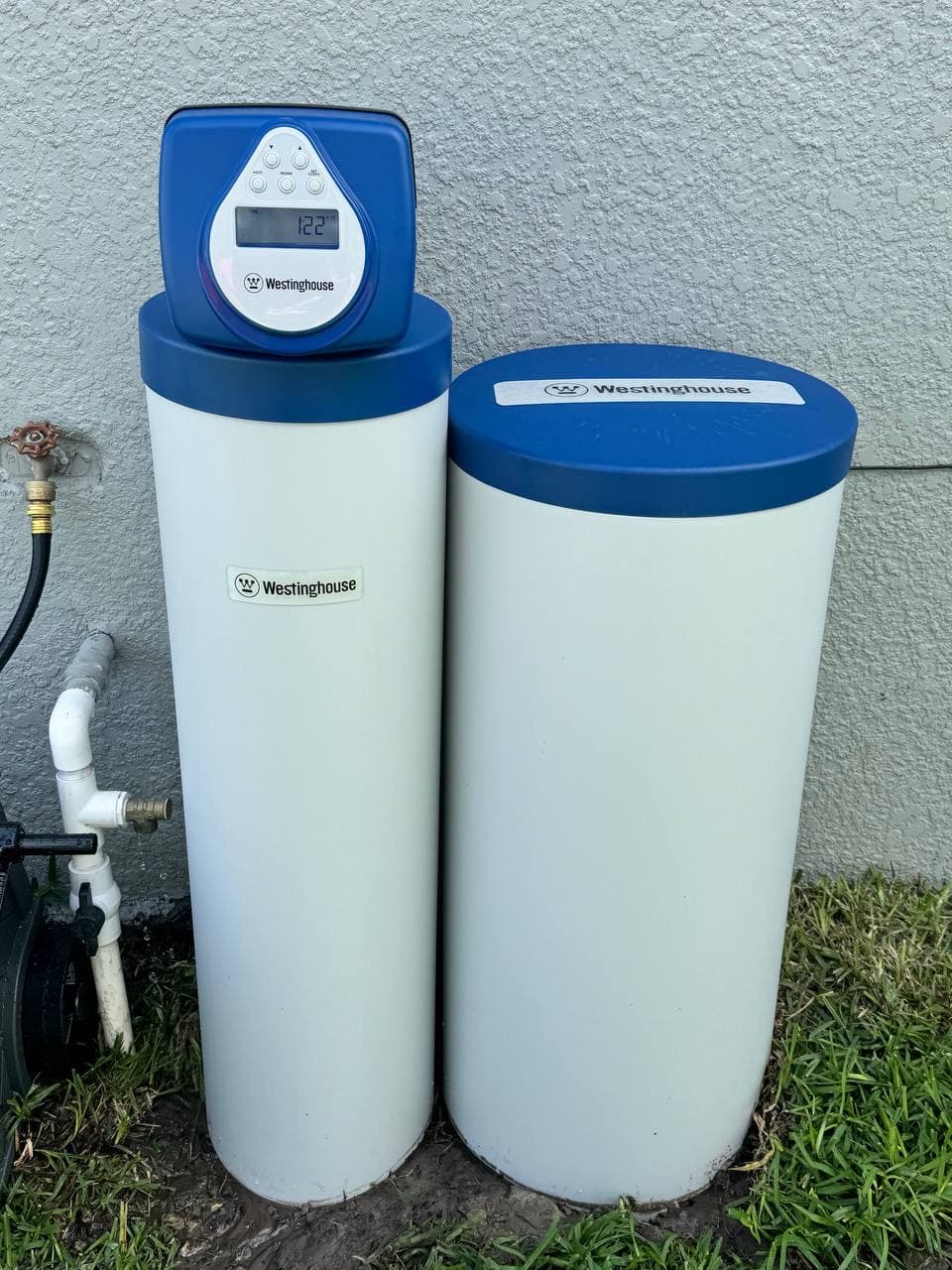 Outdoor whole-home water system with visible control head.